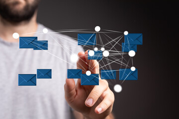 Man interacts with a digital network of emails, illustrating global communication and connectivity.