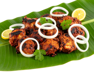- Spicy Boti Tikka Meat Chunks Served on Banana Leaf with Onion Rings, Side View, Cut Out PNG