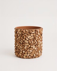 Wood chip molded biodegradable planter pot in brown on plain white background