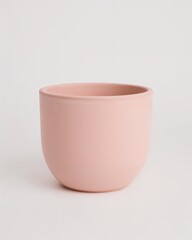 Matte pastel pink round pot with smooth finish on plain white background
