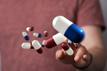 Person holding digital pills. Healthcare, pharmacy, medicine concept.