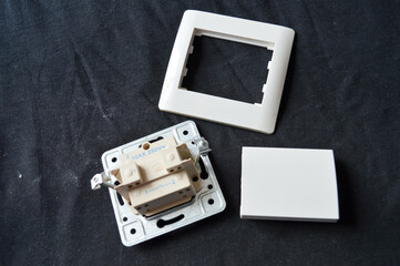 back side of electrical wall switch with visible wiring contacts and metal mounting frame, detailed...