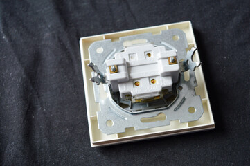 back side of electrical wall switch with visible wiring contacts and metal mounting frame, detailed...