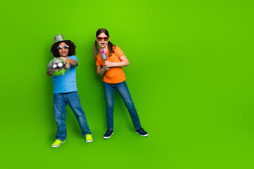 Excited children in casual clothing enjoying a playful activity with a disco ball and microphone...