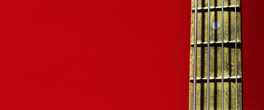 Guitar strings close-up. Guitar fretboard. Musical instrument. Hobby. Close-up of guitar neck with frets and strings. Old guitar, fragment with selective focus