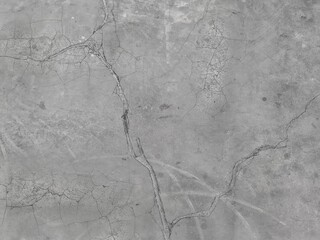 Background of cracked concrete surface. Rough surface texture of crack pattern on concrete. Cracked concrete wall surface due to age, ground movement, excessive load, or extreme temperature changes.