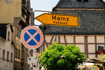 "No parking" sign and direction sign to Mainz and Koblenz in Historic Town Bacharach, Germany