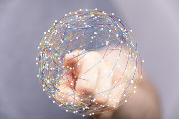 Abstract image of a hand interacting with a digital sphere representing global connections and...