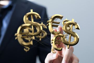 Image of a businessman interacting with 3D currency symbols, representing global finance and...