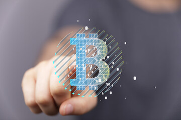 Hand pointing at a digital Bitcoin symbol. Cryptocurrency, blockchain technology, finance.