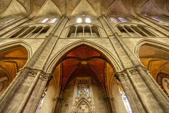 Impressive gothic architecture of Bourges Cathedral showing arches, pillars and stained glass windows