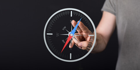 Hand interacts with a compass, symbolizing guidance, direction, and strategy. Ideal for business,...