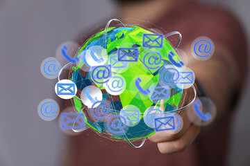 Image of a person interacting with a digital globe showing communication icons. Represents global...