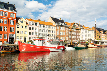 Historic facades reflect in Nyhavn's tranquil waters