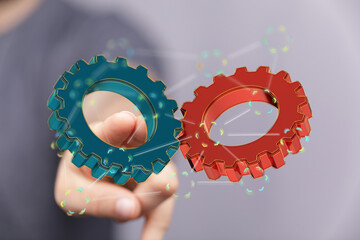Image of two gears meshing, symbolizing teamwork, collaboration, and synergy.