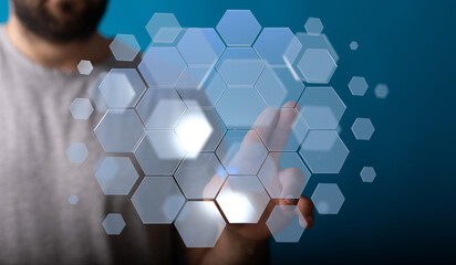 Abstract image of a hand interacting with a digital hexagon interface.  Technology, innovation,...