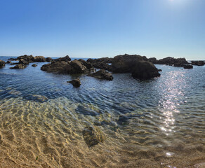 The Gondarem Beach in Foz do Douro, Porto, Portugal. Calm tide over rocky coastline and coarse sand, perfect for resting and relaxing in the summer by the Atlantic shore.