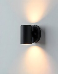 Minimalist black cylindrical wall light creating a beautiful up-down illumination pattern.