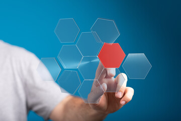 Person interacts with a digital hexagon network, highlighting a key data point.