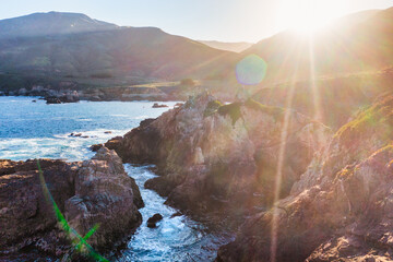 Sunset view of Garrapata State Park Bluff Trail along Highway 1, with rocky cliffs, deep blue...