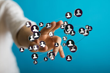 Hand interacting with a network of connected people, symbolizing social media, global connections,...