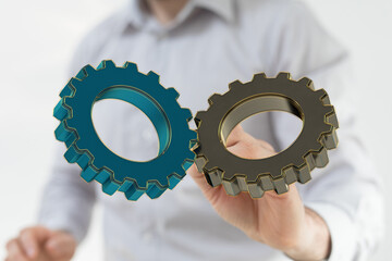 Image of two gears interlocked, symbolizing teamwork, collaboration, and synergy in business.