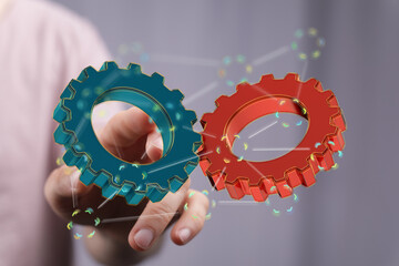 Image of two gears meshing, symbolizing teamwork, collaboration, and synergy in business.