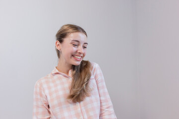 Young woman styling her hair in front of a mirror