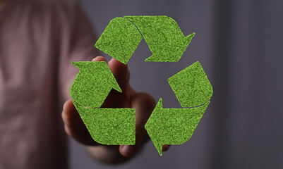 Eco-friendly concept image featuring a person holding a green recycling symbol. Perfect for...