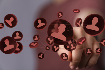 Hand interacts with a network of digital profiles, symbolizing online connections and social media...