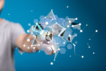 Abstract image of a hand interacting with a complex digital network, representing technology,...