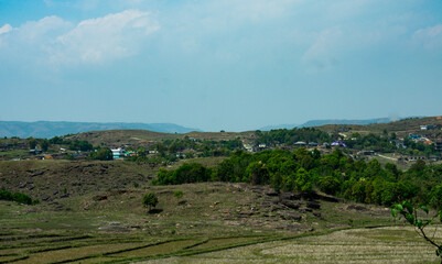 Rural village nestled in rolling hills and fields in Meghalaya. 