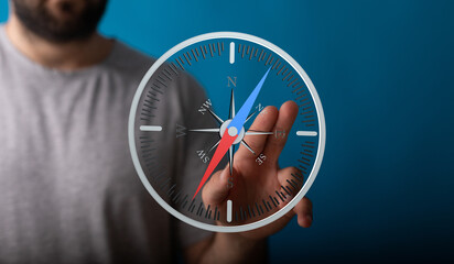 Stock photo of a man using a digital compass app on a touchscreen device.  Find your way.