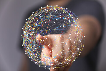 Abstract image of a hand interacting with a digital globe, representing global network, connection,...