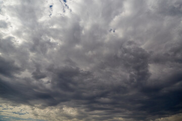 A large Fractus cloud in the sky blocking sunlight, background of clouds, clouds before a change in...
