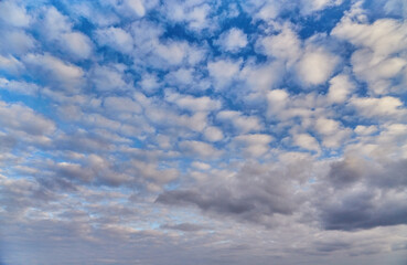 Light blue sky with airy clouds—a symbol of childhood and carefree moments, innocence, joy, and nostalgia.