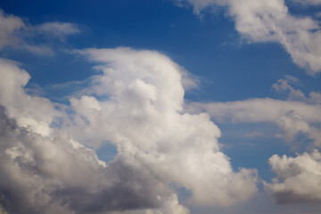 A photo featuring the contrast of a white cloud against a deep blue sky symbolizes opposites and balance.