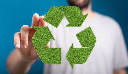 Person interacting with a green recycle symbol. Eco-friendly concept.