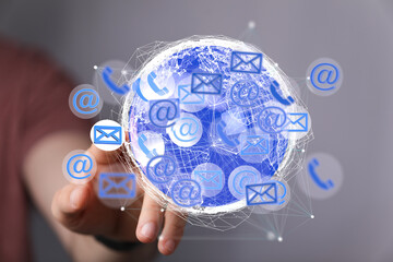 Image depicts a digital globe with email, phone, and contact icons. Represents global communication...