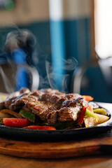 smoking grilled meat and veggies