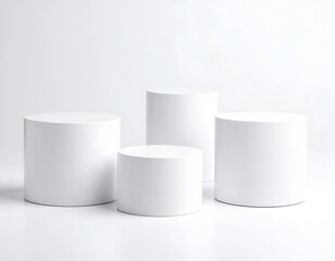 Clean white cylindrical pedestals create a minimalist backdrop for modern product display.