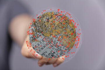 A hand holds a digital globe showing interconnected points.  Network, connection, global concept.