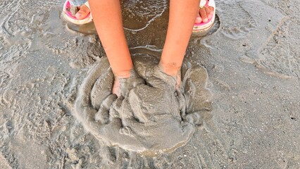 Child Playing with Mud – Hands Digging in Wet Sand – Fun Outdoor Activity Concept