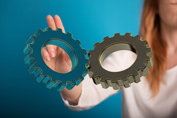 Image of woman holding digital gears. Perfect for teamwork, collaboration, and business concepts.