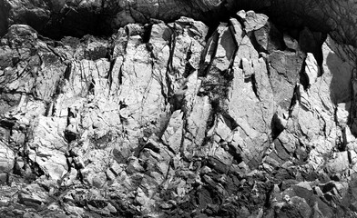 Rock structure on the Californian coast near Carpinteria. Coarse, rough surface with light and...