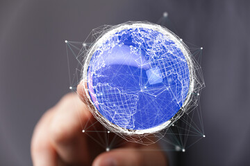 Abstract image of a hand holding a digital earth, representing global connectivity and networking.