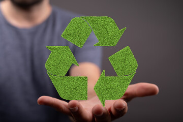 Eco-friendly concept image showing a recycling symbol made of grass.