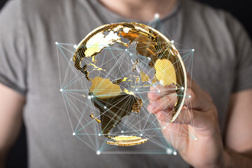 Person interacts with a 3D digital globe, showcasing global network connections and data...