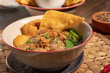 Bakso kuah in rooster bowl served with fried dumpling and vegetables. Ideal for Indonesian comfort...