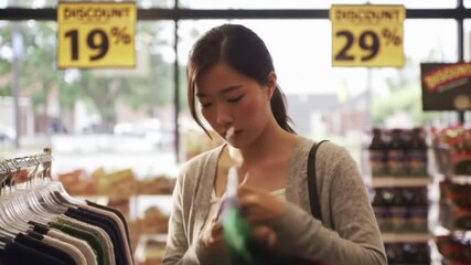Woman Browsing Clothing Rack in Store Choosing Garment